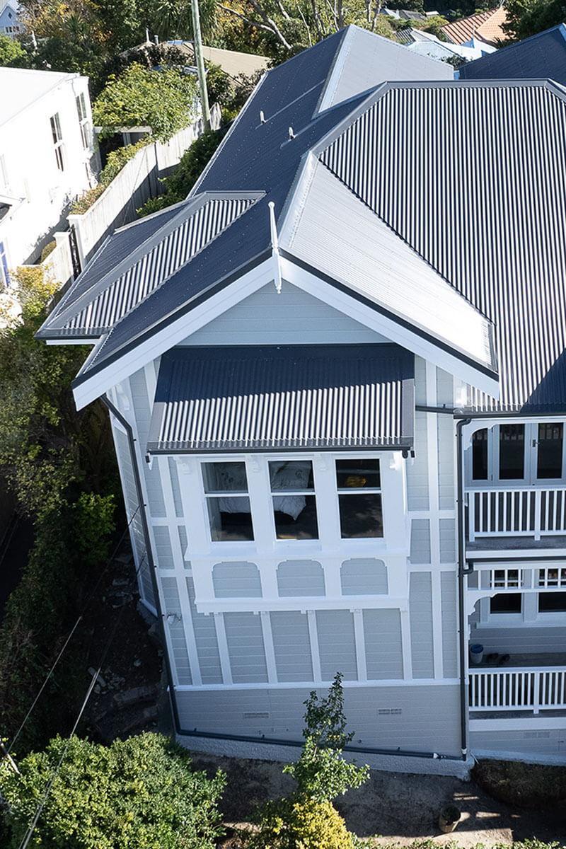 Project Central Terrace 3 Exterior front aerial shot off renovated old, blue and white, victorian home with tin roof